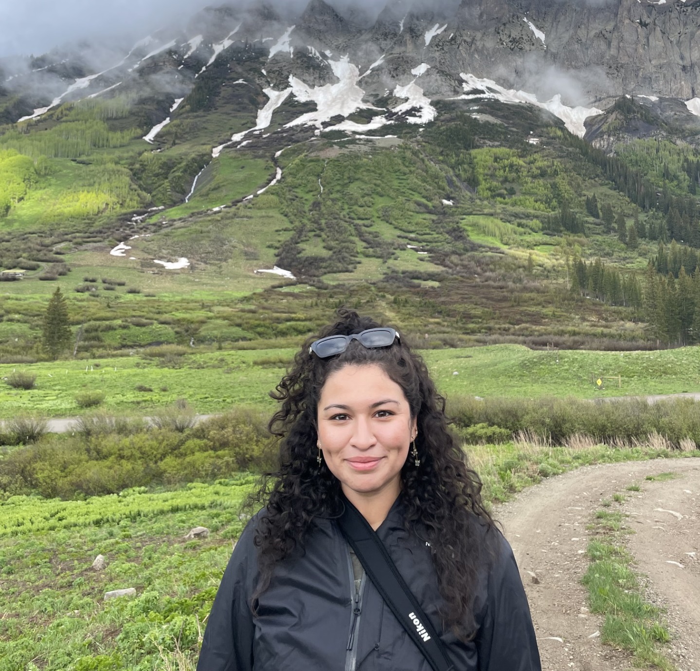 Photo of Luz Salinas in front of lightly snowed mountain