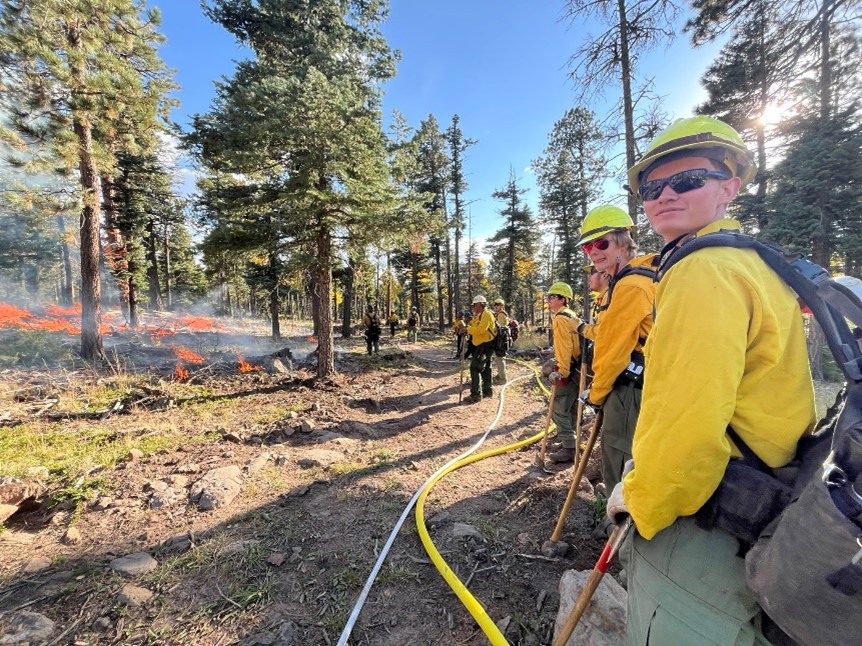 FSYC members watch a prescribed burn from the burn break.