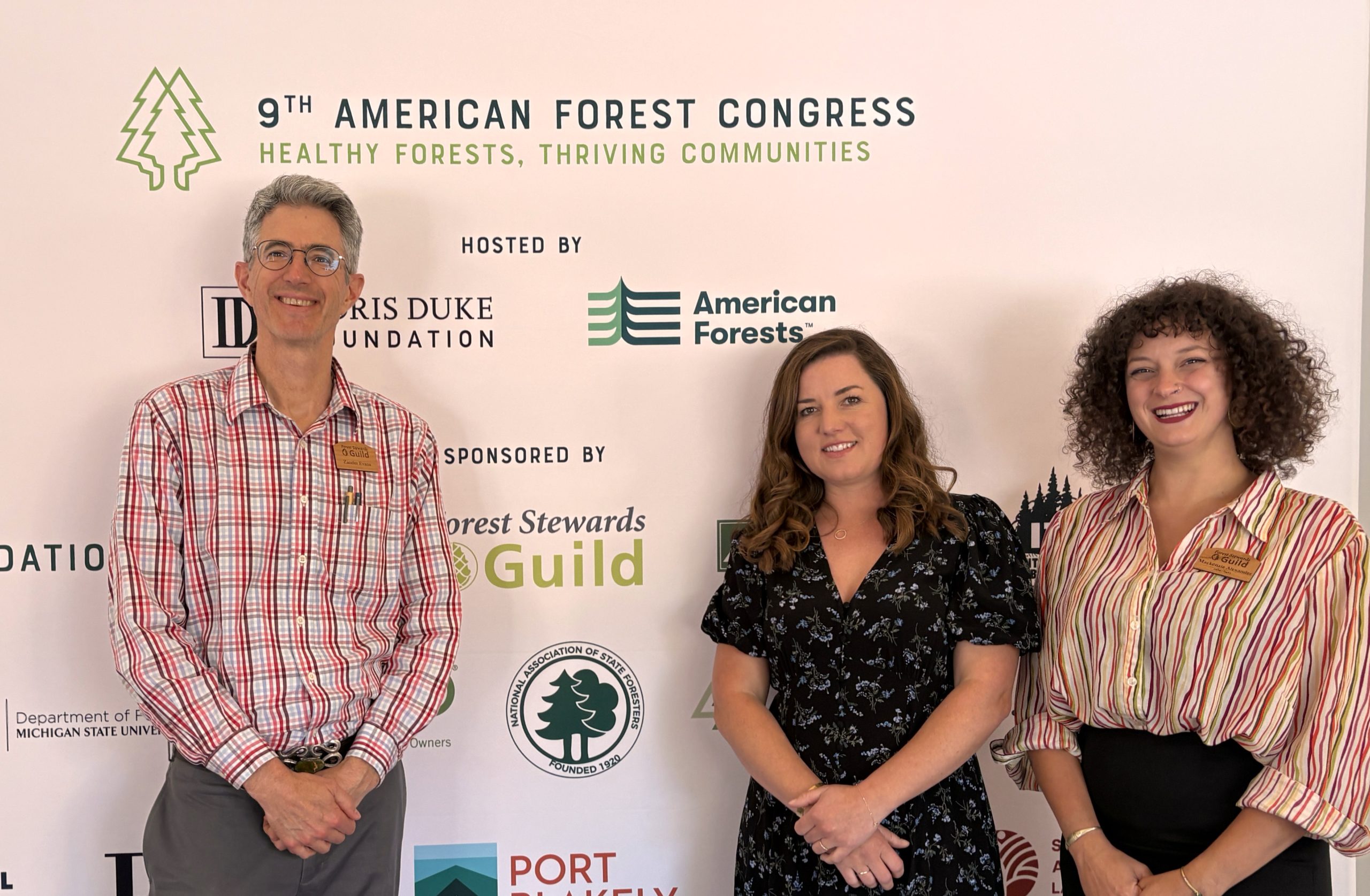 Rachel wearing a blue t-shirt in front of a Southwest landscape resembling the Grand Canyon